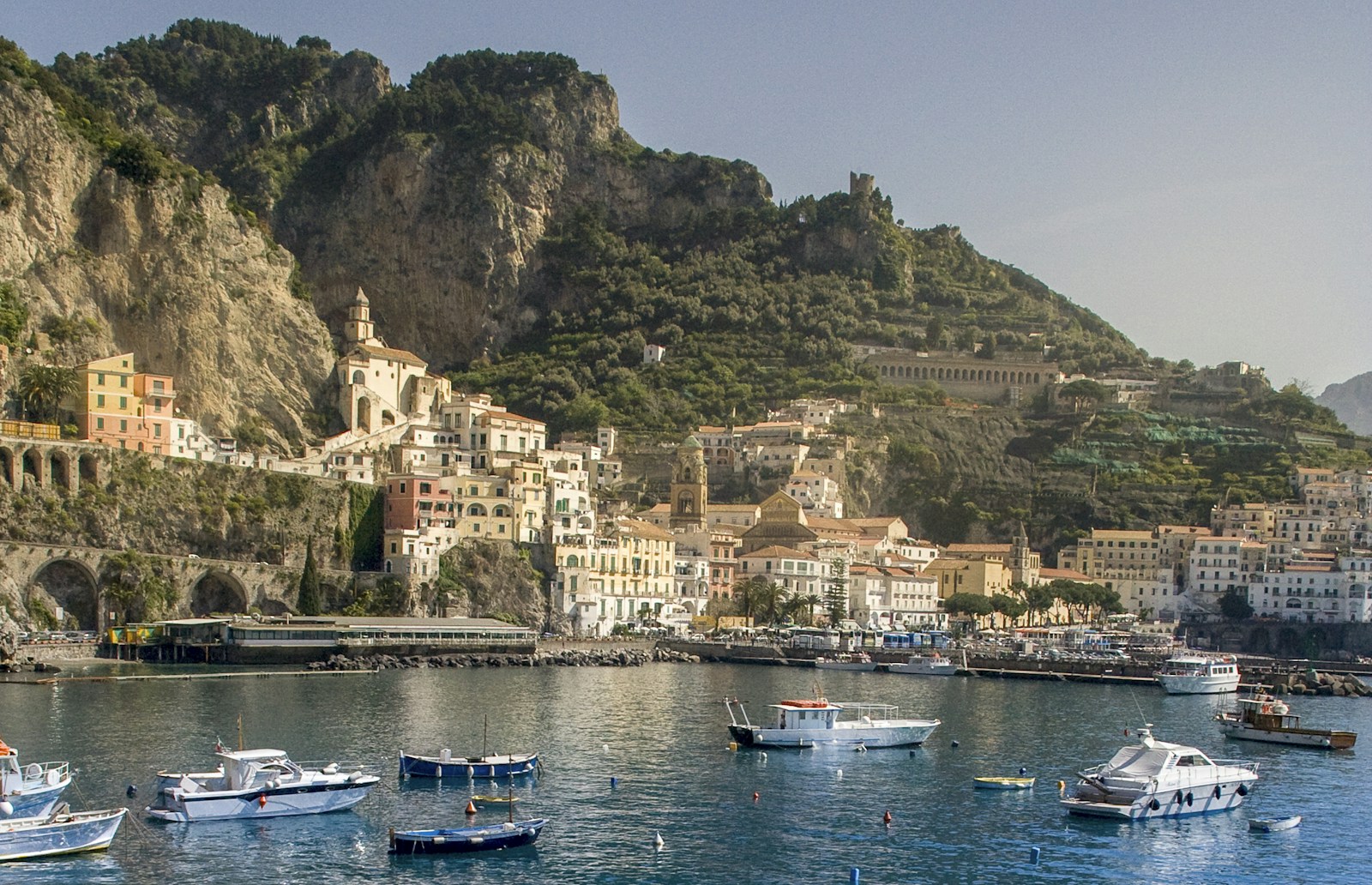 Boats in the harbor beneath Amalfi’s coastal hillside